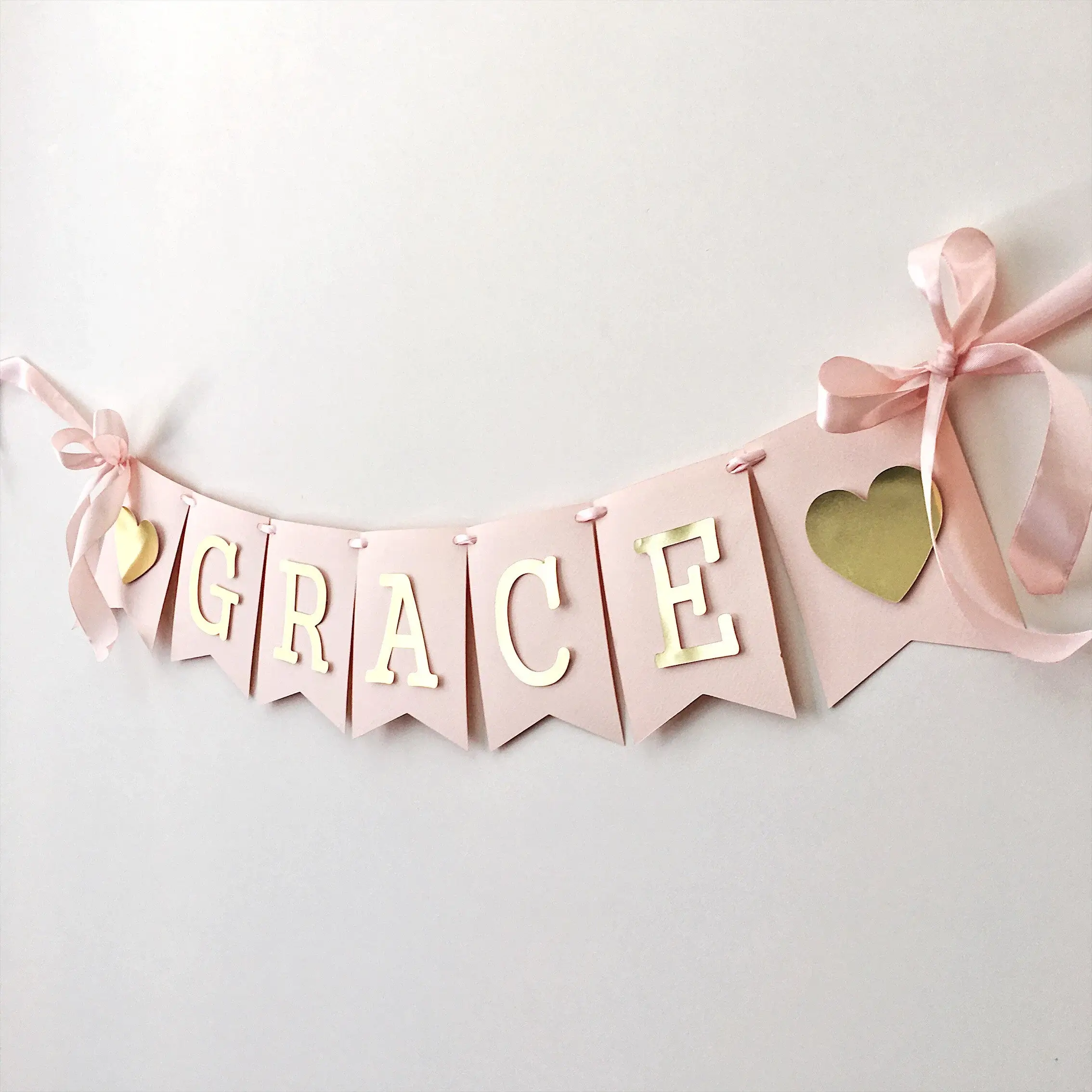 Elevate the party decor with a personalised celebration banner, featuring the little one's name