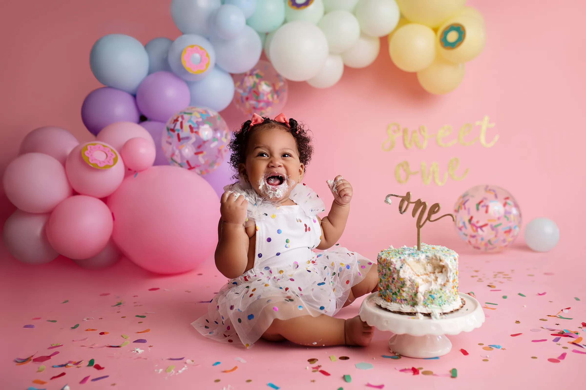 Creating cherished memories as the little one explores their first taste of birthday cake