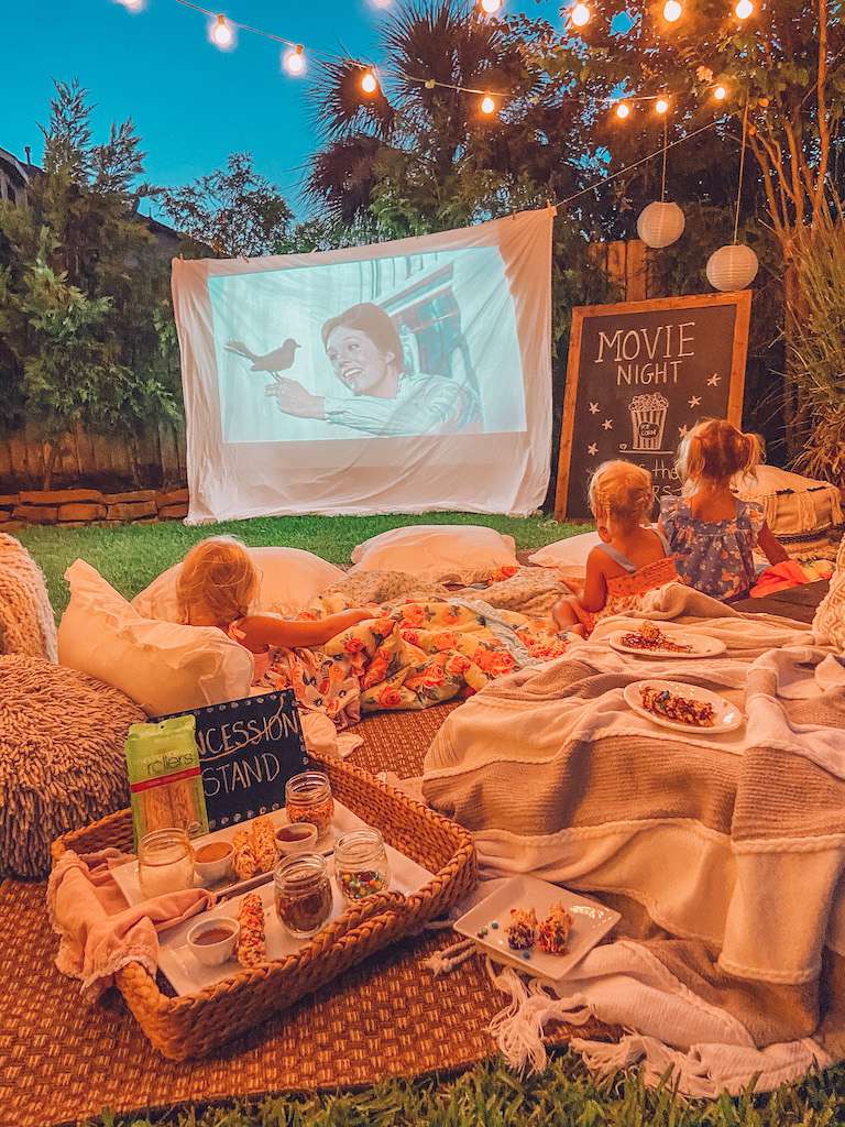 Transform your backyard into a cosy cinema offering guests a magical outdoor movie night experience under the stars