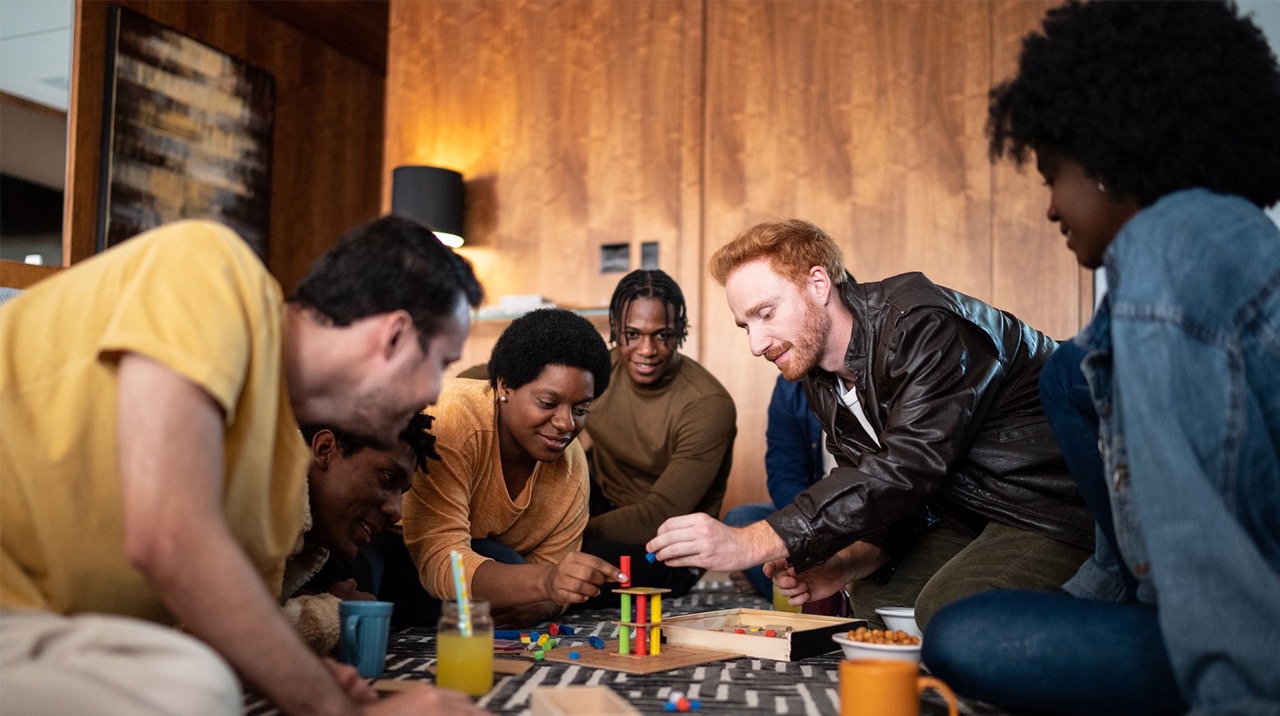 a group of friends playing puzzle at home